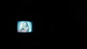 A suspenseful horror video scene with a shadowy figure, creating a mysterious, chilling vibe for viewers.